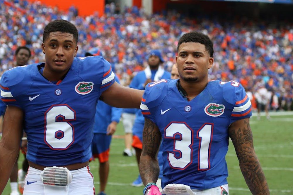 <p>UF cornerbacks Jalen Tabor and Quincy Wilson (left) walk off the field following Florida's 40-14 win against Missouri on Oct. 15, 2016, at Ben Hill Griffin Stadium.</p>