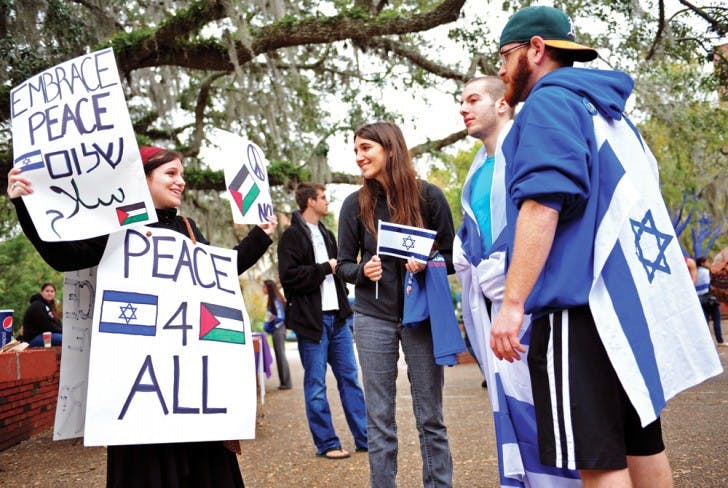 Jewish studies and political science student Jaimie Krass, 21, came independently to Turlington Plaza Thursday to promote peace during a rally split between support of Israel and Palestine. "Both sides are so preoccupied with pointing fingers," Krass said. "We've forgotten to come together for a common goal: peace."