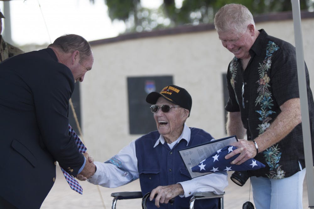 Charles D. Moloney, a 95-year-old World War II veteran, shakes the hand of Rep. Ted Yoho during a ceremony honoring Moloney's service during WWII at Camp Blanding Joint Training Center on Friday. Moloney enlisted in the U.S. Army on April 4,1942, and received six medals on Friday that he hadn't received after leaving the U.S. Army.