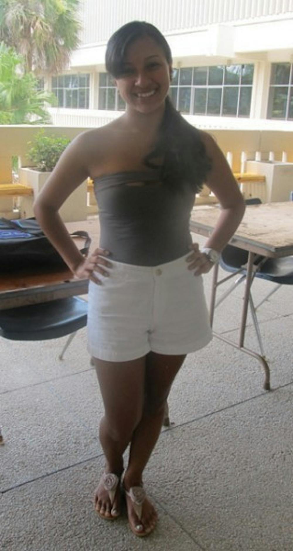 <p>UF junior Jennifer Rodriguez goes for a cute and casual look by pairing a gray strapless shirt, tucked into high-waisted white shorts, with neutral sandals. "I got these shoes for $8 at a store called 888 back home," Rodriguez said. "I get a bargain on everything I buy there."</p>