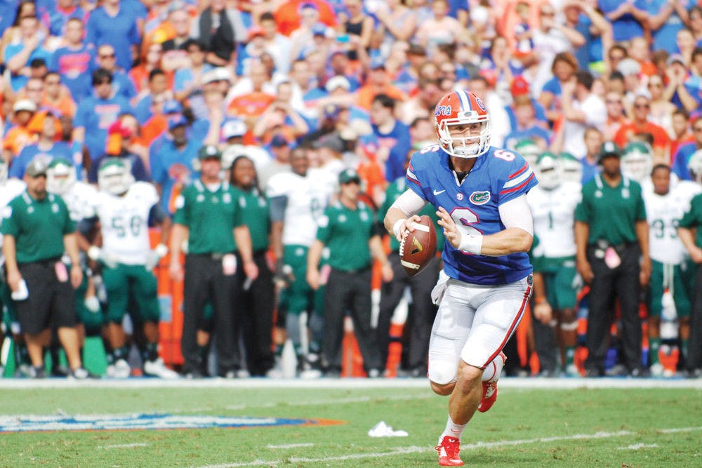 <p>Jeff Driskel scrambles in the backfield during Florida's 65-0 win against Eastern Michigan on Saturday at Ben Hill Griffin Stadium.</p>
