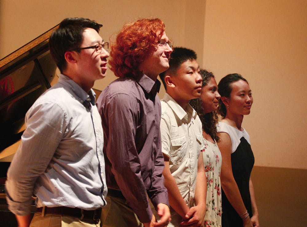 Performers Bomin Park, Mayan Essak, Zhao Yuhang, Anna Gilliland and Christina Lai (left to right) rise to bow for the audience at the first piano recital held for the International Piano Festival on Saturday. The event brings together outstanding pianists from around the world for daily masterclasses and evening recitals with guest artists from North America and China.