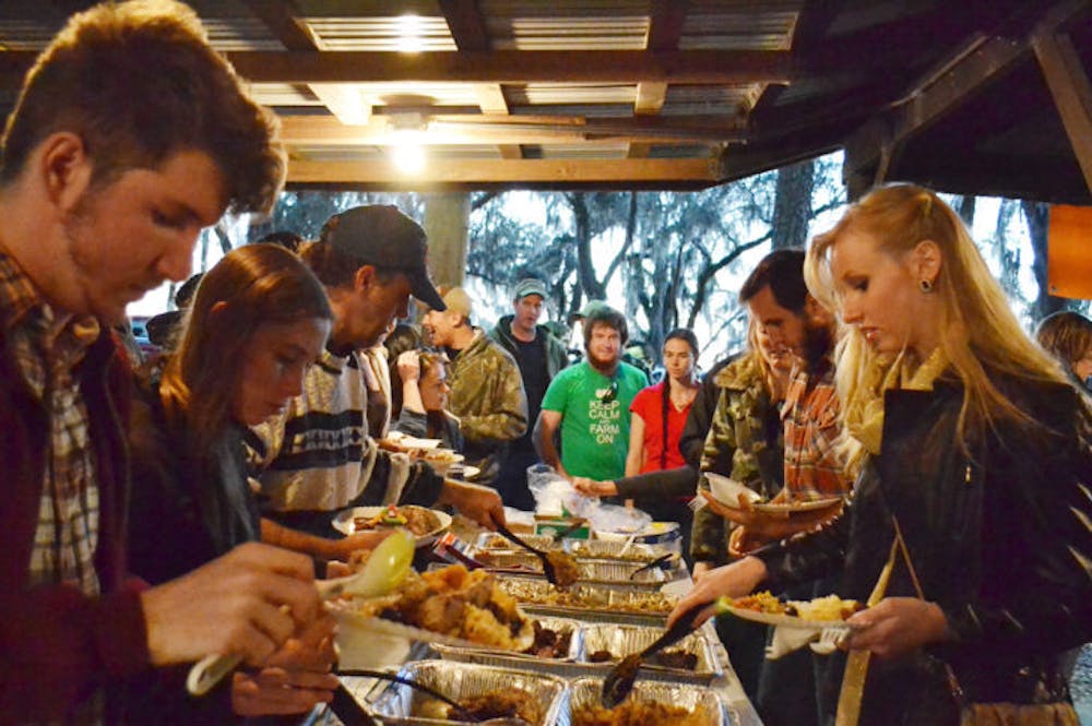 <p class="p1">People <span class="s1">line up for a buffet of wild game at the 31st Annual Beast Feast on Saturday. The event, with dishes such as pheasant, boar and venison, benefited the UF Wildlife Society.</span></p>