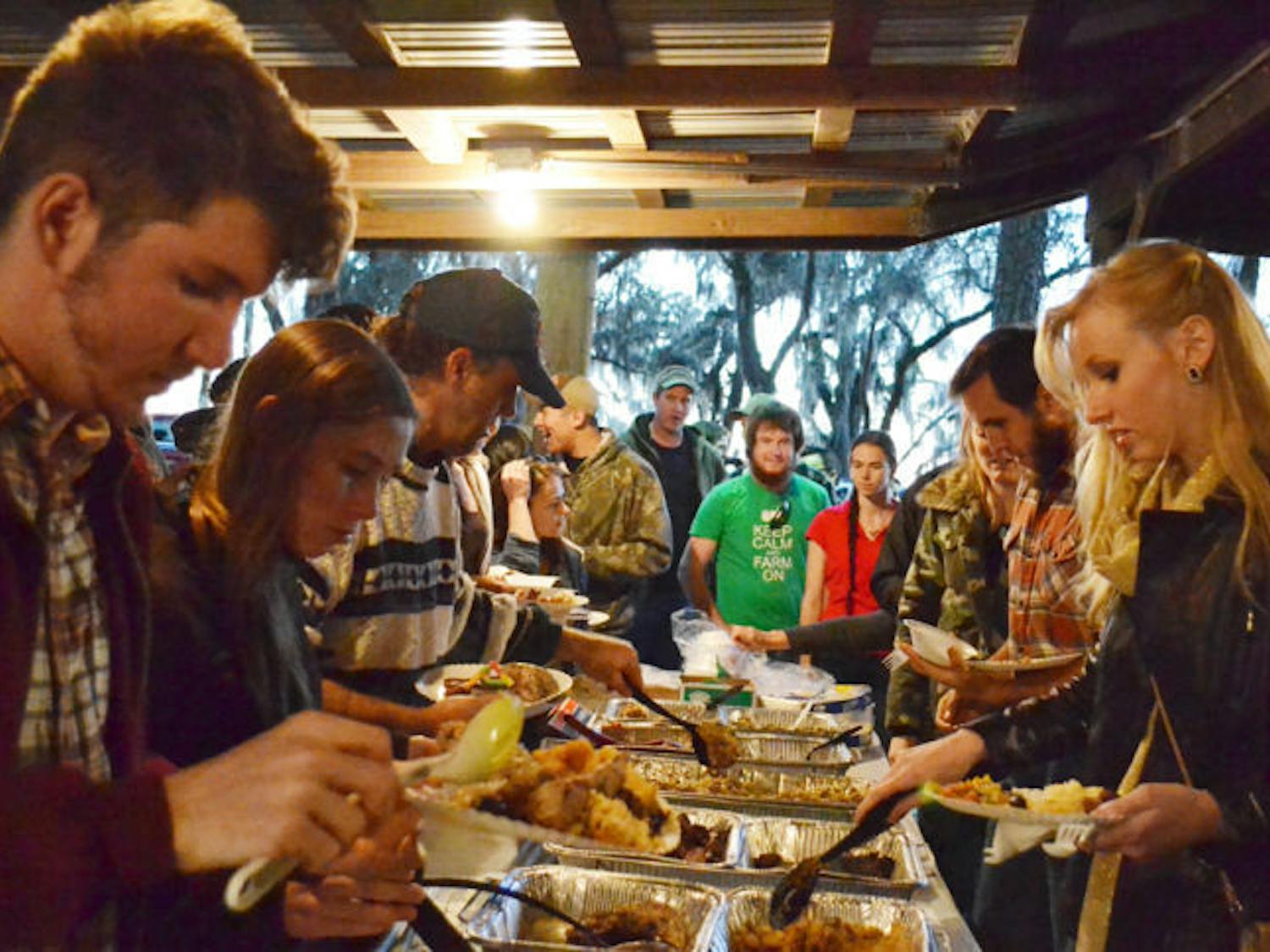 People line up for a buffet of wild game at the 31st Annual Beast Feast on Saturday. The event, with dishes such as pheasant, boar and venison, benefited the UF Wildlife Society.
