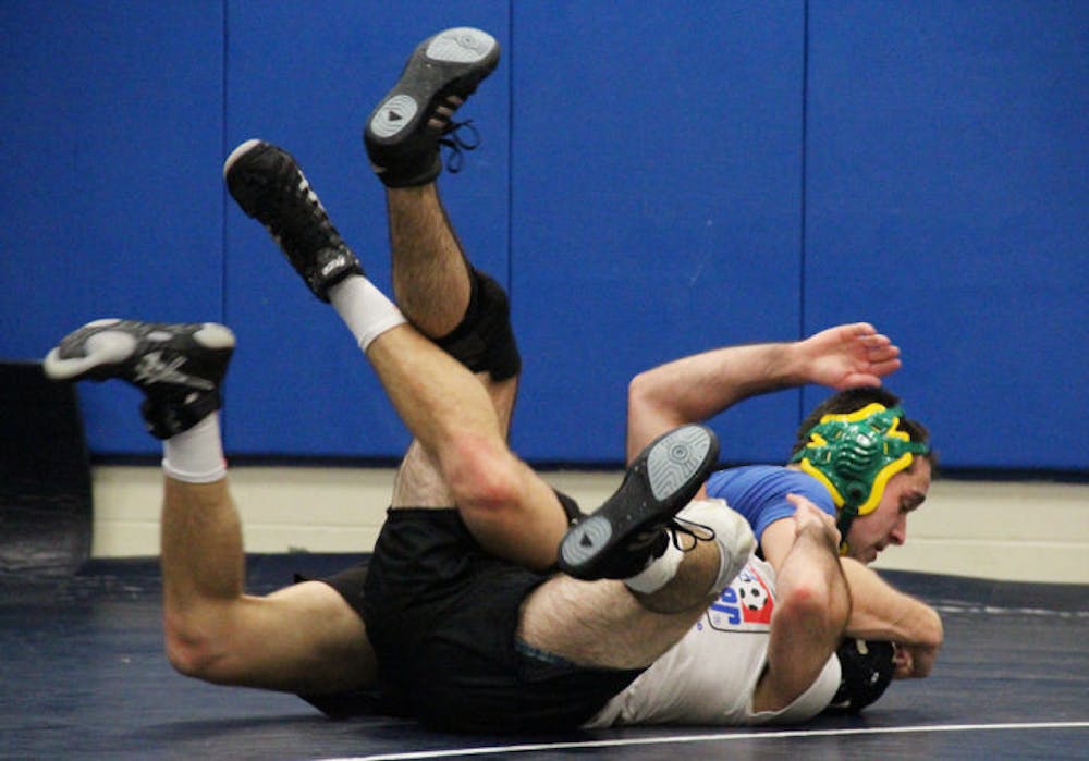 <p>Brandon Russakis, 29, a mechanical engineering junior, pins Josh Weinberg, 20, a biology sophomore, at wrestling practice at Southwest Recreation Center on Thursday night.</p>