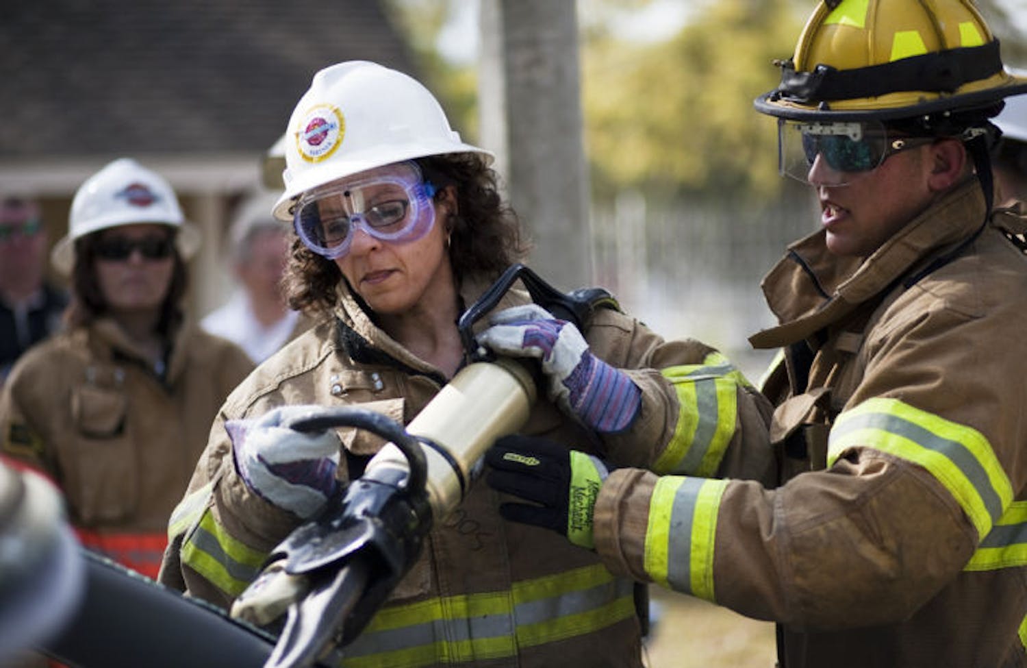 Firefighter Joey Gonzalez, right, teaches Odette Hinson, left, how to operate the Jaws of Life at the Second Annual Citizens Fire Academy held Saturday at the Gainesville Fire Rescue training facility.&nbsp;