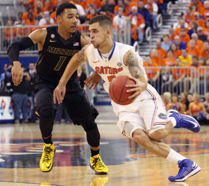 Florida guard Scottie Wilbekin (right) dribbles past Missouri guard Phil Pressey during the Gators’ 83-52 win against the Tigers on Saturday in the O’Connell Center.
