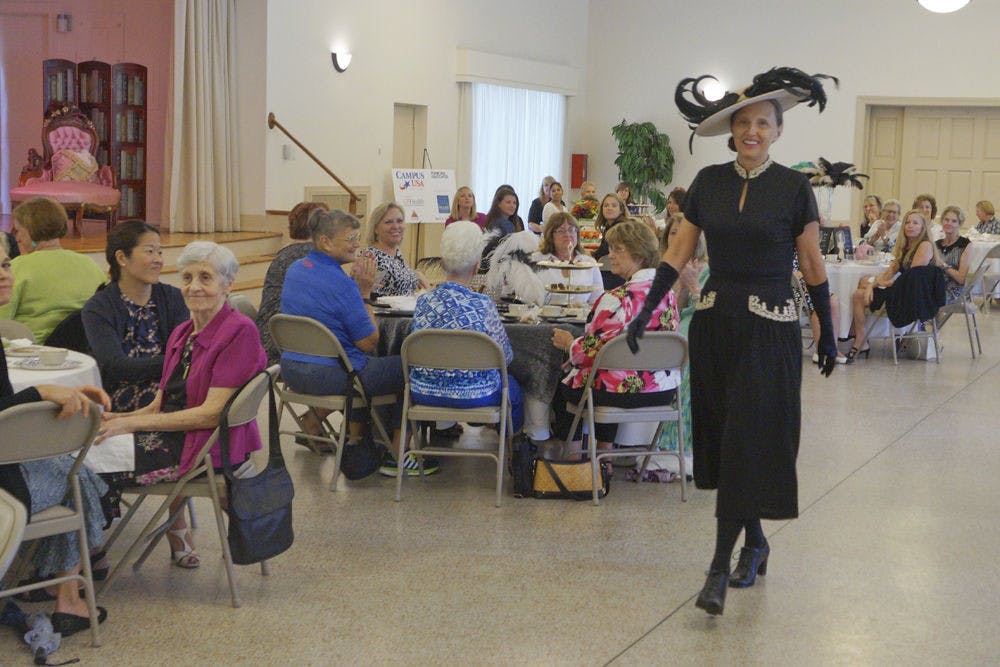 Linda Fuchs, UF President Kent Fuchs' wife, walks down the runway in era clothing during a time period fashion show at the Gainesville Woman’s Club Sept. 10, 2015. The event raised money for the Climb for Cancer Foundation and the oncofertility program at UF.