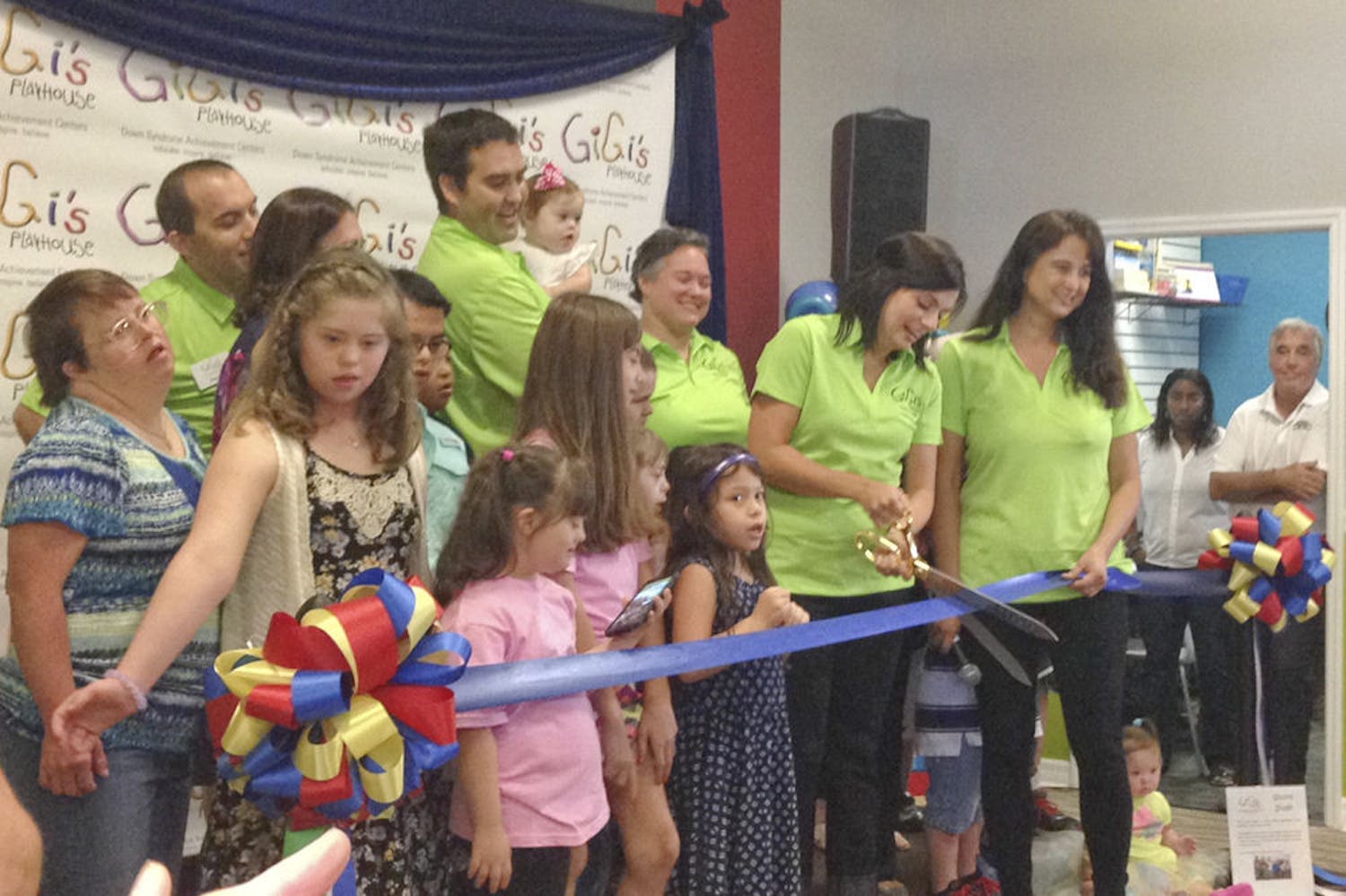 Addie Dalton, a board member for Gigi’s Playcenter, a nonprofit organization for children with Down Syndrome, snips a ribbon at the center’s grand opening on Oct. 11, 2015. The center provides a space for children and families with down syndrome to build confidence through learning, performing and socializing.