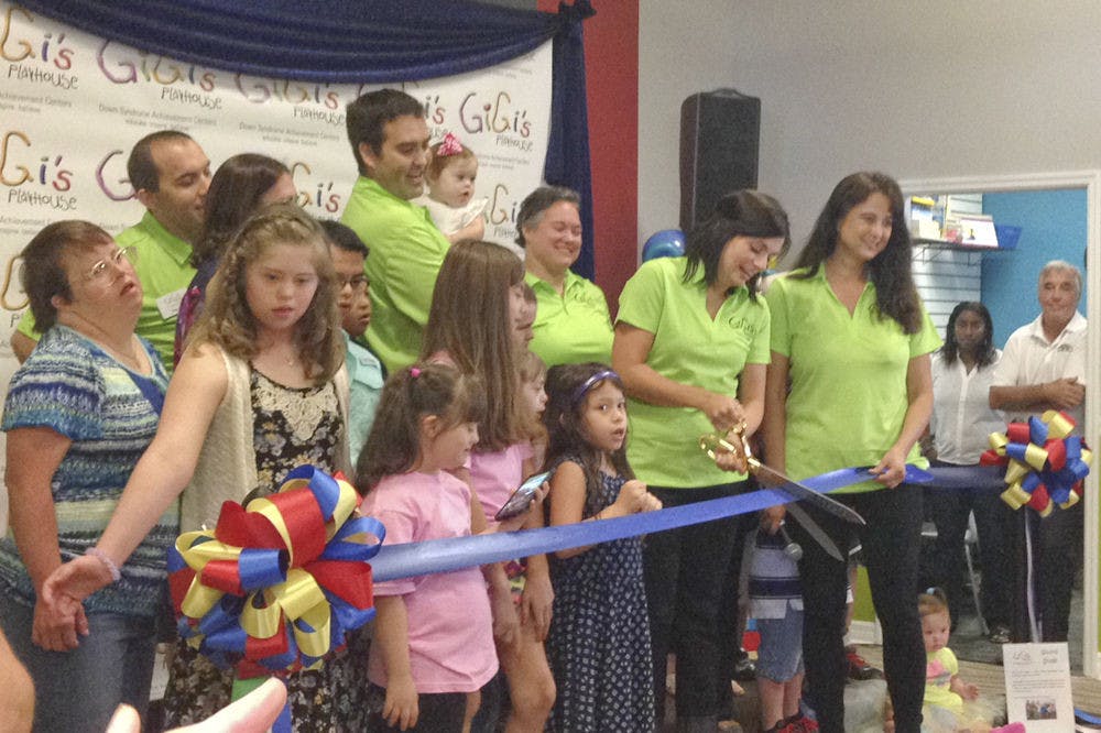 <p>Addie Dalton, a board member for Gigi’s Playcenter, a nonprofit organization for children with Down Syndrome, snips a ribbon at the center’s grand opening on Oct. 11, 2015. The center provides a space for children and families with down syndrome to build confidence through learning, performing and socializing.</p>