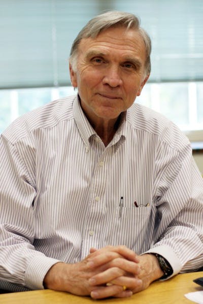 Economics professor David Denslow, 69, poses for a picture in his office on Monday.