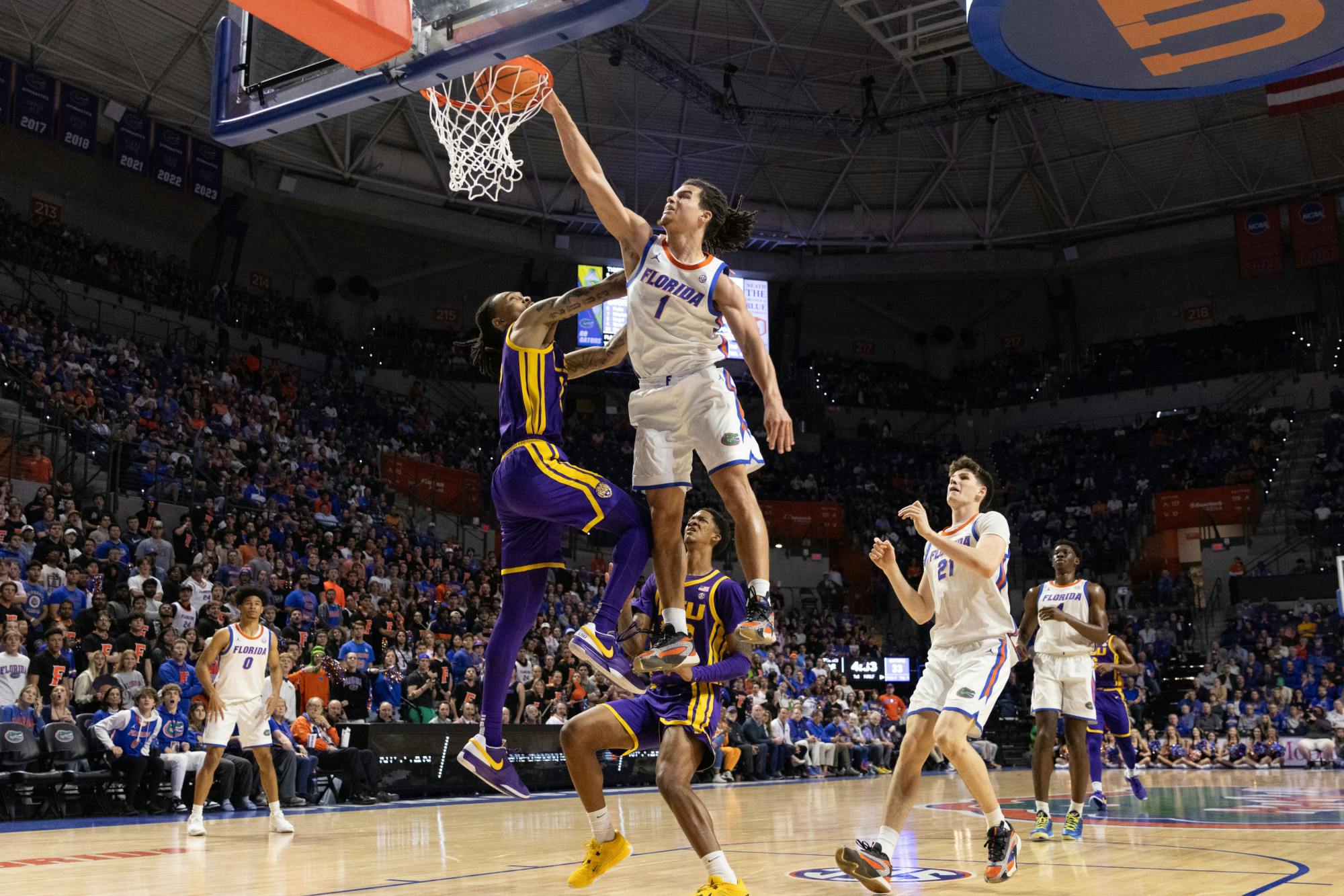 Florida men's basketball guard Walter Clayton Jr. dunks on LSU forward Tyrell Ward in the Gators win over LSU on Tuesday, February 13, 2024. 