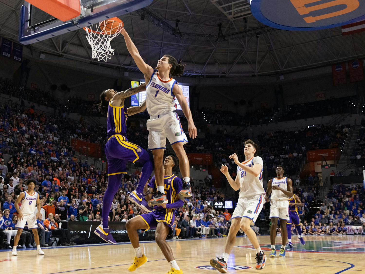 Florida men's basketball guard Walter Clayton Jr. dunks on LSU forward Tyrell Ward in the Gators win over LSU on Tuesday, February 13, 2024. 