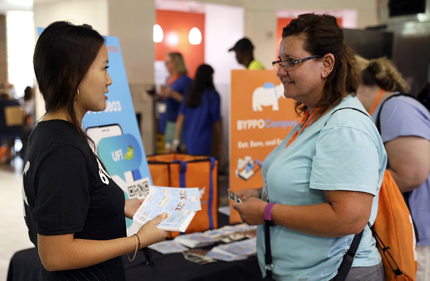 BYPPOCAMPUS founder and CEO Victoria Liu, (left) a UF accounting alumna, introduces her food delivery business to Stephanie Landini, (right) a parent of a UF student, at Gator Dining Center in Gainesville on Friday, July 9, 2021.