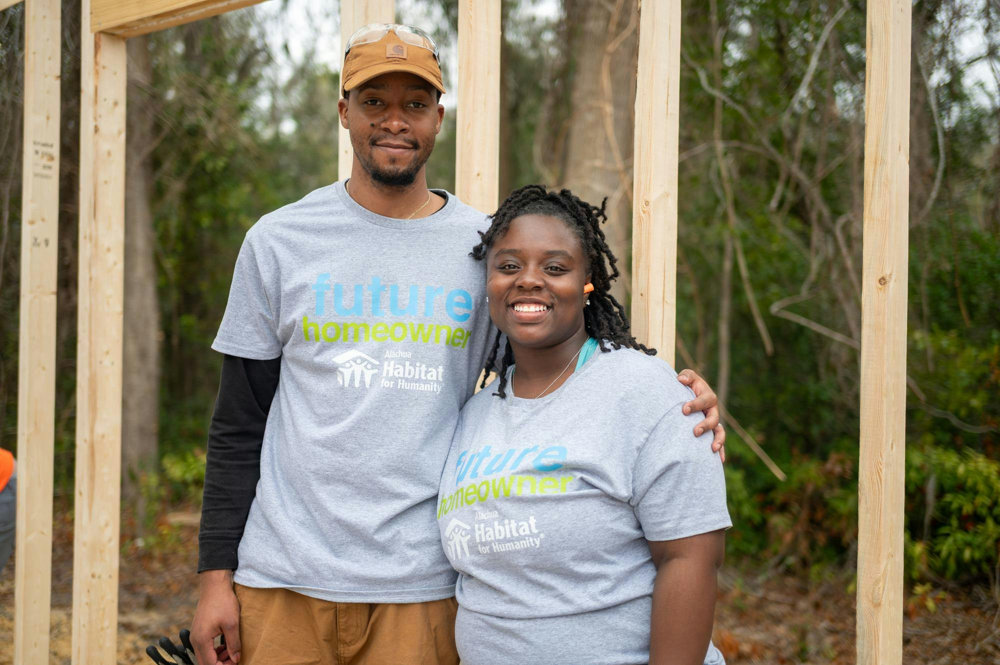 Xavier and Tamara Filer pose together in front of what will soon be their new home, Saturday, Feb. 28, 2026, in High Springs, Fla.