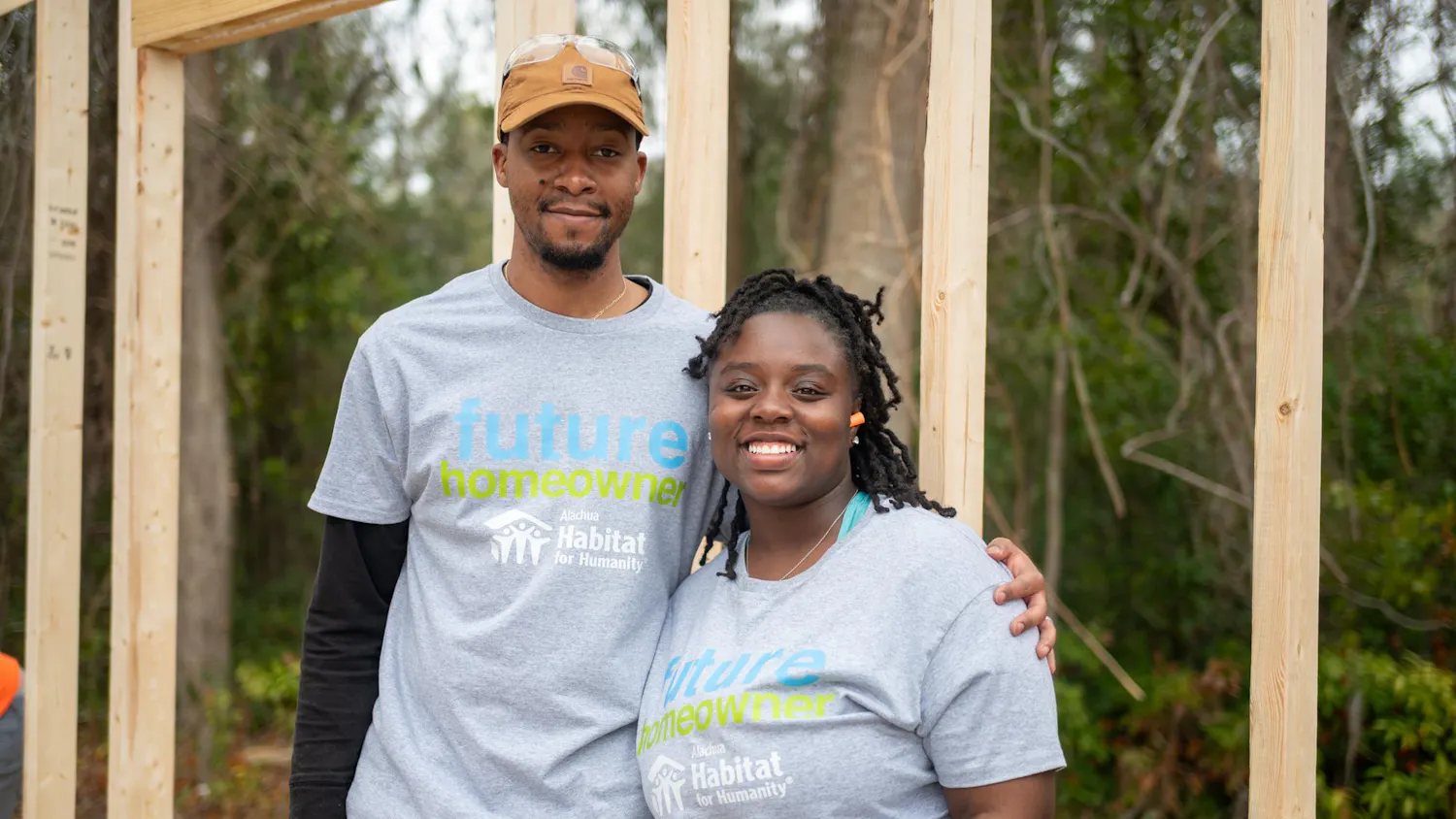 Xavier and Tamara Filer pose together in front of what will soon be their new home, Saturday, Feb. 28, 2026, in High Springs, Fla.