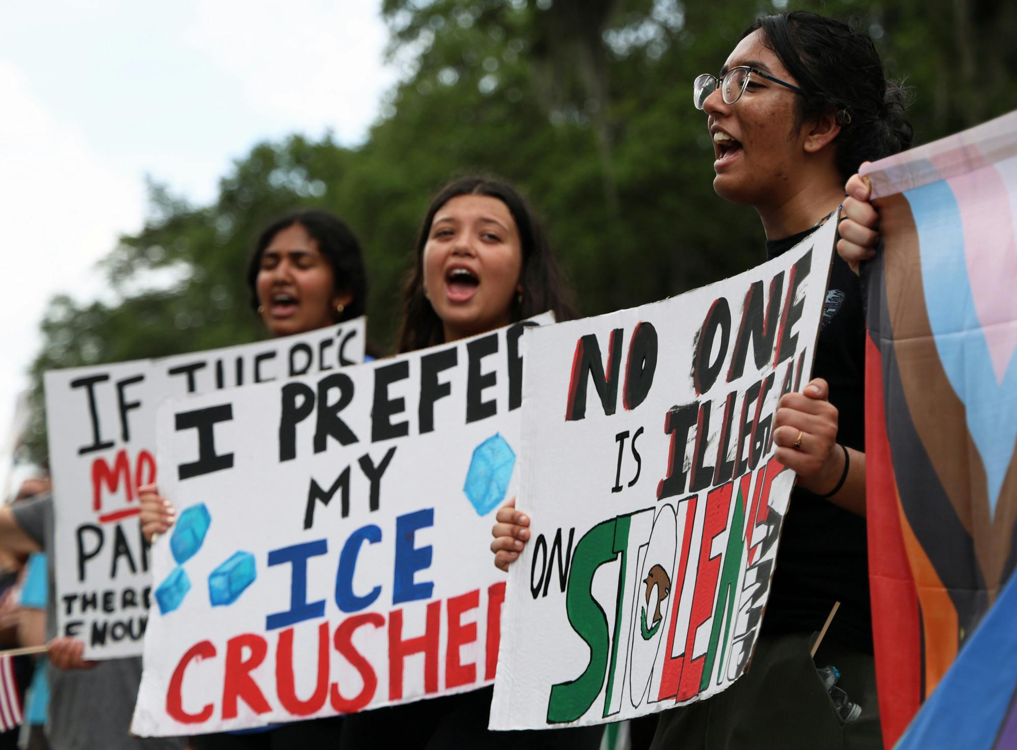 Anwitha Sriraha (far right) chants with her friends Savannah Kesser (center) and Thanmal Yakkanti (far left) on Southwest Sixth Street during the "No Kings Day" protest on Saturday, June 14, 2025. 