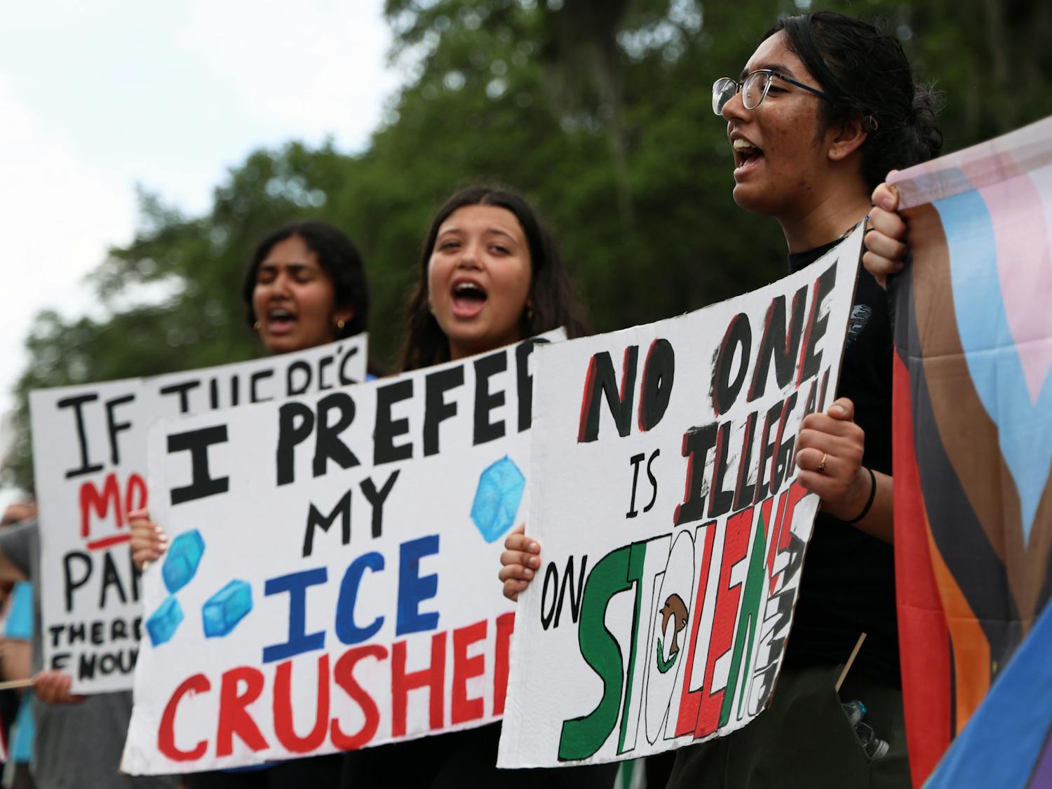 Anwitha Sriraha (far right) chants with her friends Savannah Kesser (center) and Thanmal Yakkanti (far left) on Southwest Sixth Street during the "No Kings Day" protest on Saturday, June 14, 2025.