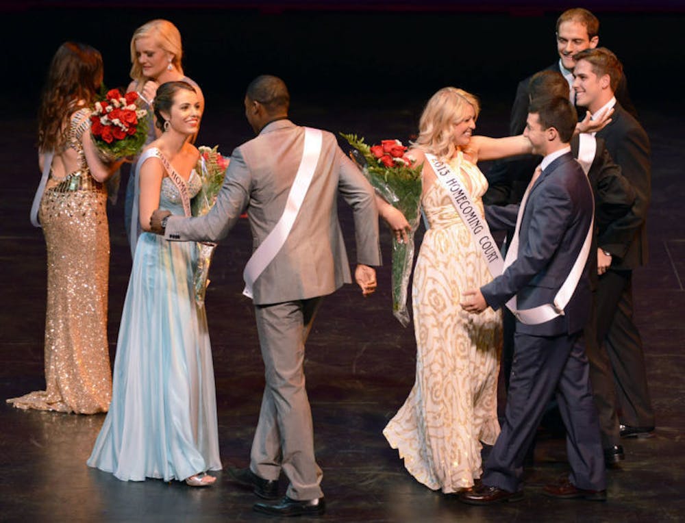 <p>Olivia Barket, left, hugs Jayce Victor as Abby Whiddon, right, hugs Daniel Landesberg on Tuesday evening after finding out they placed as finalists in the UF Homecoming Pageant, held at the Phillips Center for the Performing Arts on Tuesday.</p>
