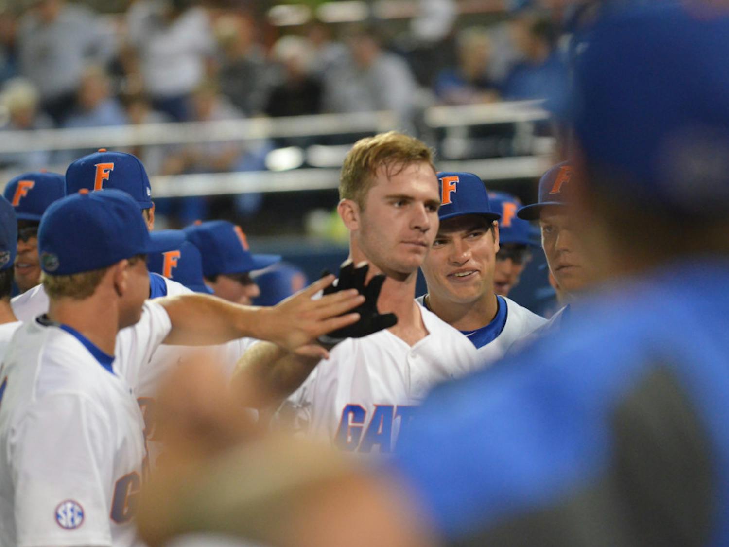 Peter Alonso celebrates with teammates after hitting a home run during Florida's win against Texas A&M on April 1, 2016, at McKethan Stadium.