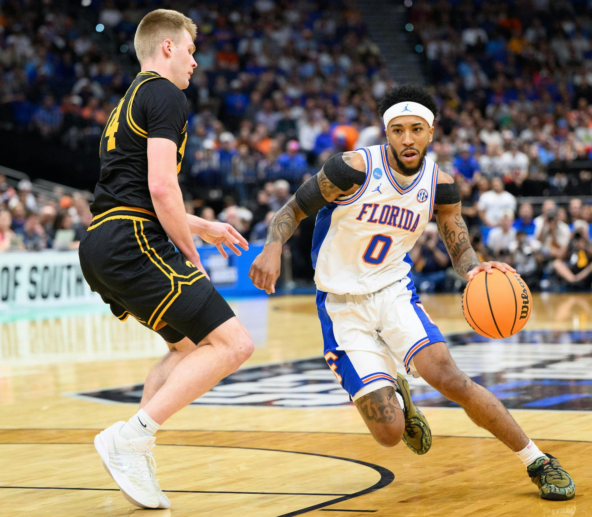 Florida guard Boogie Fland (0) drives against Iowa guard Bennett Stirtz (14) during the first half of an NCAA Tournament second round game against Iowa, Saturday, March 22, 2026, in Tampa, Fla.