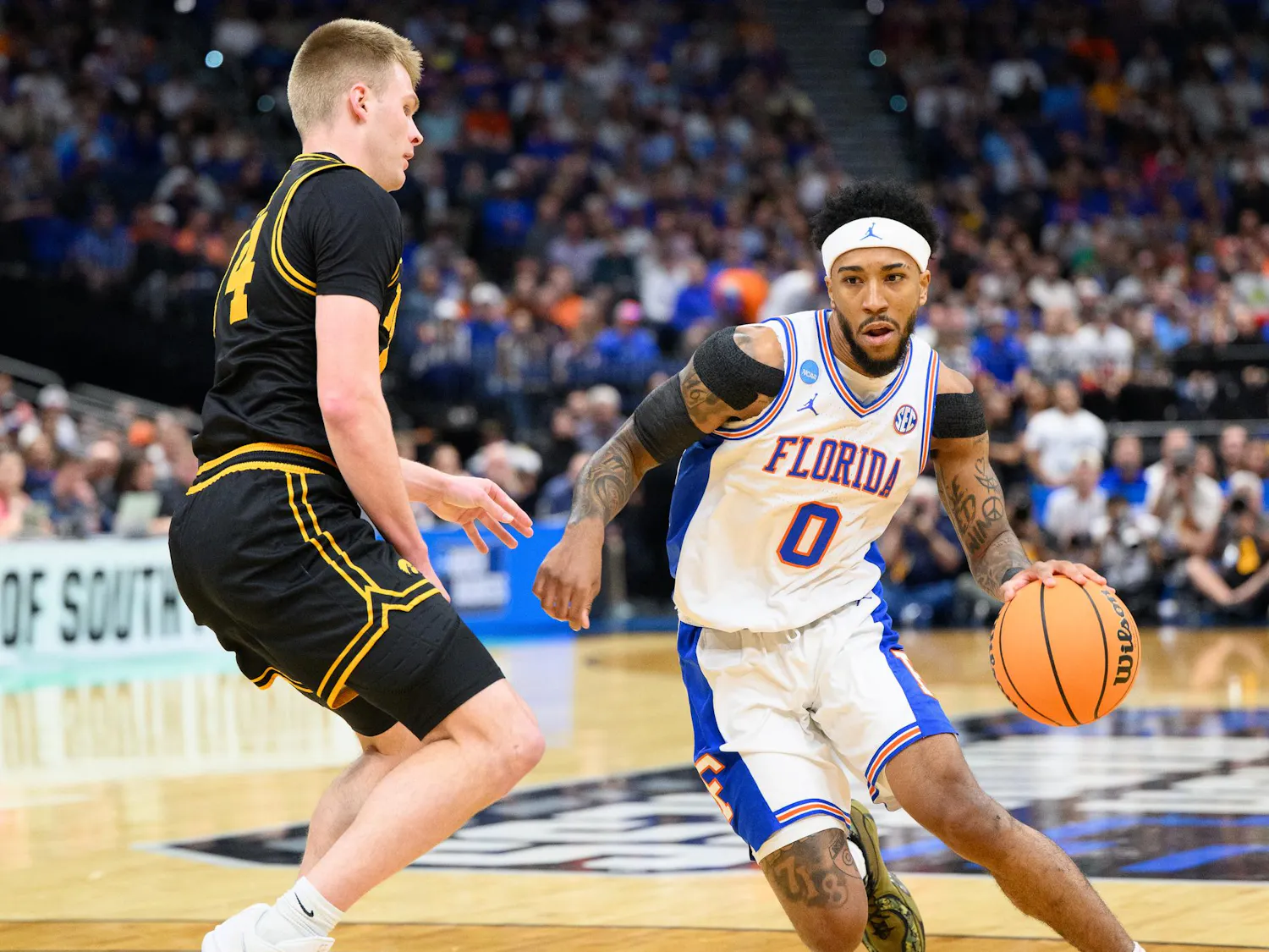 Florida guard Boogie Fland (0) drives against Iowa guard Bennett Stirtz (14) during the first half of an NCAA Tournament second round game against Iowa, Saturday, March 22, 2026, in Tampa, Fla.