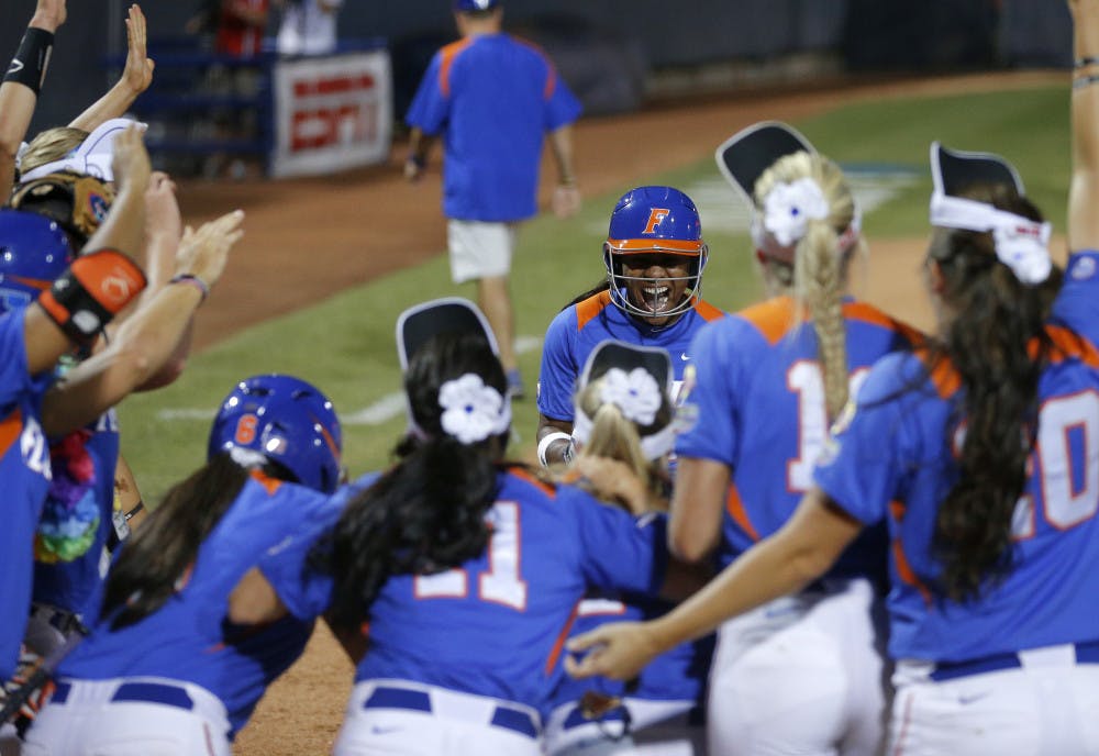 <p>Junior Briana Little is greeted at home after hitting a home run in the 10th inning during Florida's 9-8 win against Nebraska in the Women's College World Series on Saturday night in Oklahoma City.</p>