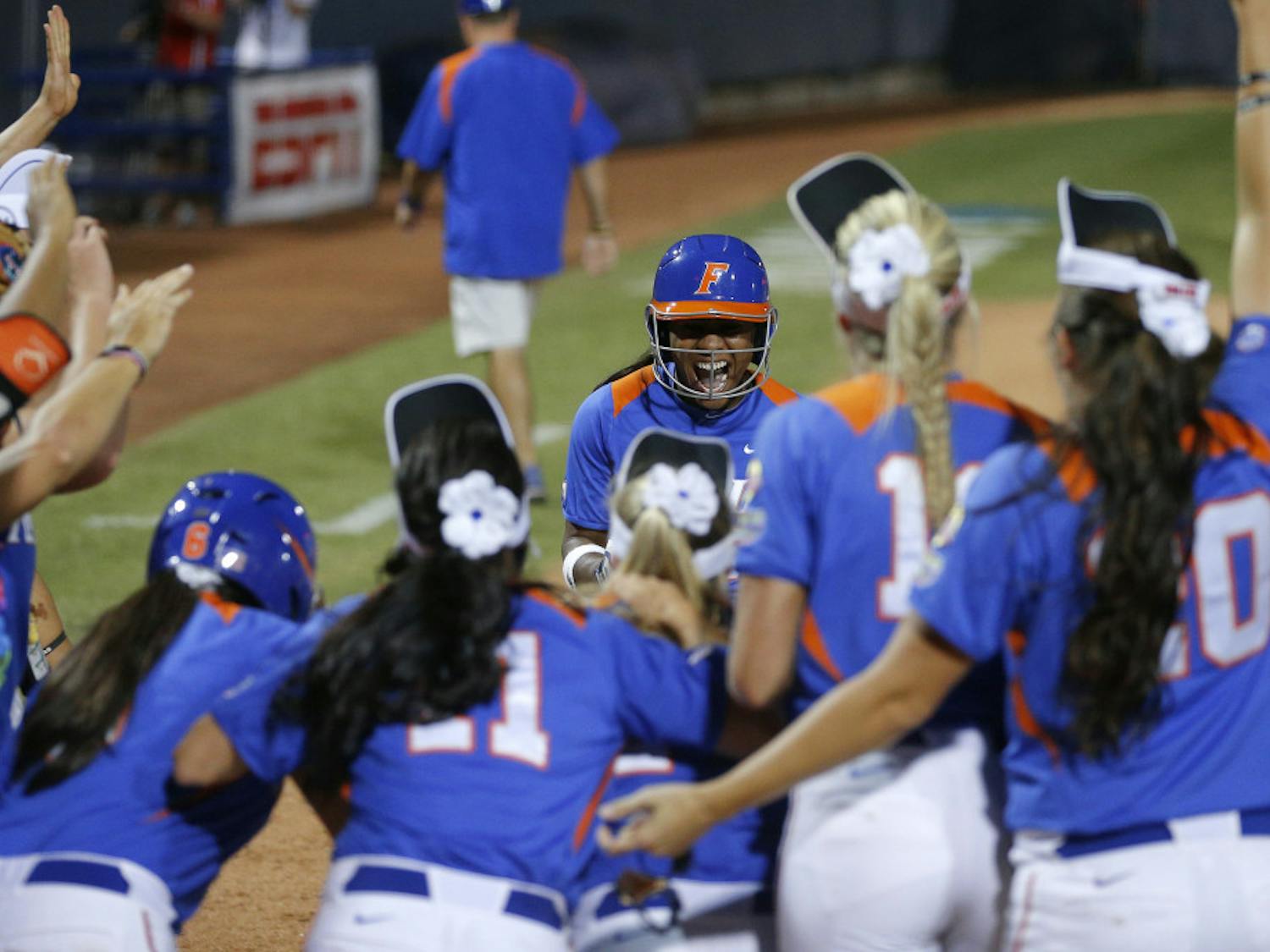 Junior Briana Little is greeted at home after hitting a home run in the 10th inning during Florida's 9-8 win against Nebraska in the Women's College World Series on Saturday night in Oklahoma City.