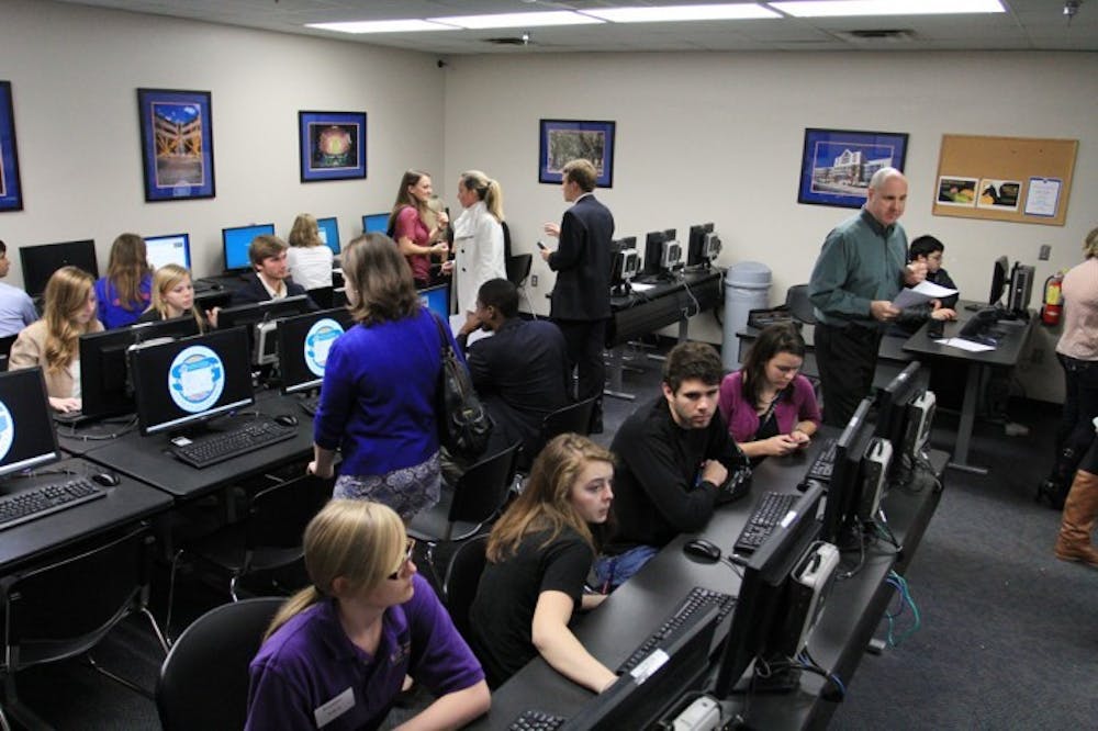 <p>Student Government members test the secure-voting system in a mock election in the Reitz Union printing lab Tuesday night.</p>