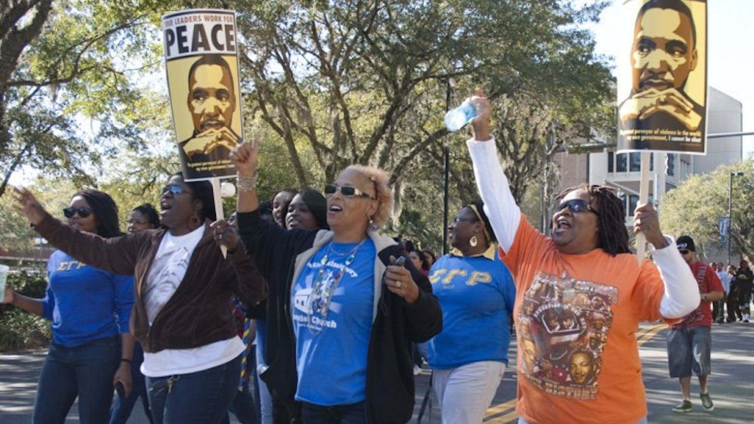 Marchers celebrate the life and work of Martin Luther King Jr. at the annual King Celebration Commemorative March on Monday afternoon in Bo Diddley Community Plaza.