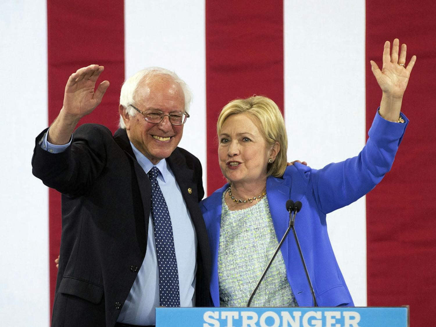Democratic presidential candidate Hillary Clinton waves to supporters with Sen. Bernie Sanders, I-Vt., during a rally in Portsmouth, N.H., Tuesday, July 12, 2016, where Sanders endorsed her for president.