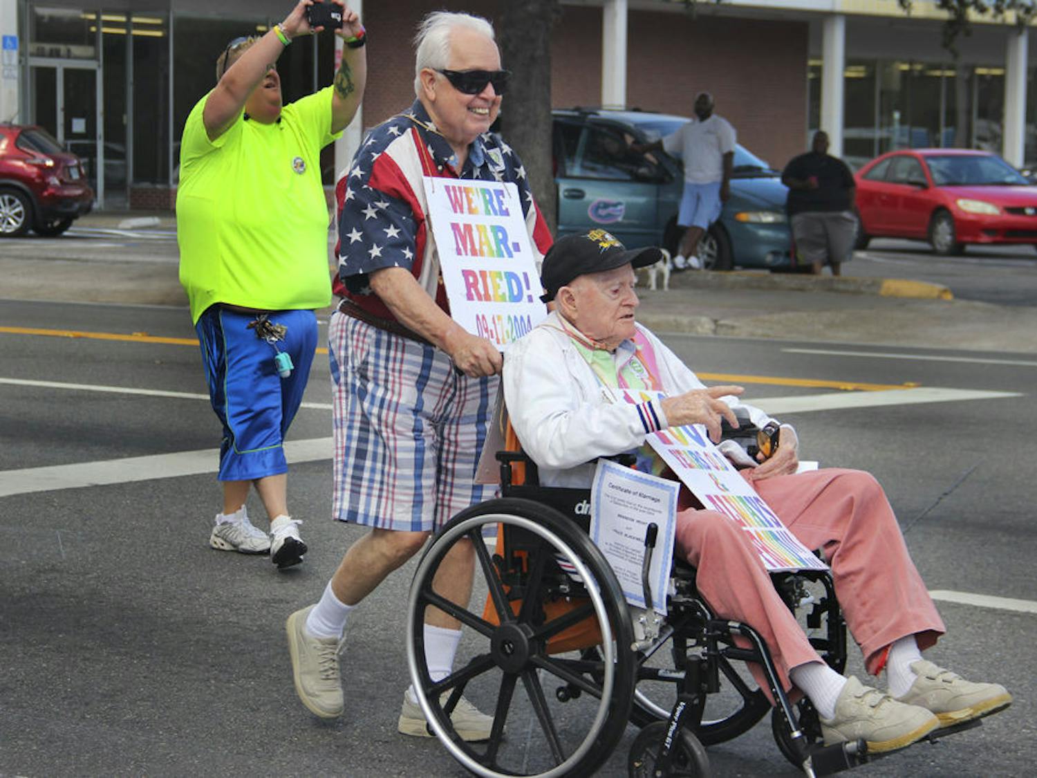 Bruce Blackwell (left) and Brandy Wight celebrate marriage equality in the Gainesville Pride Parade and Festival on Oct. 24, 2015. The two have been a couple since 1966 and got married in Martha’s Vineyard on Sept. 17, 2004. This year is special for them not only because of the Supreme Court’s ruling for marriage equality, but also because Wight is 100 years old.