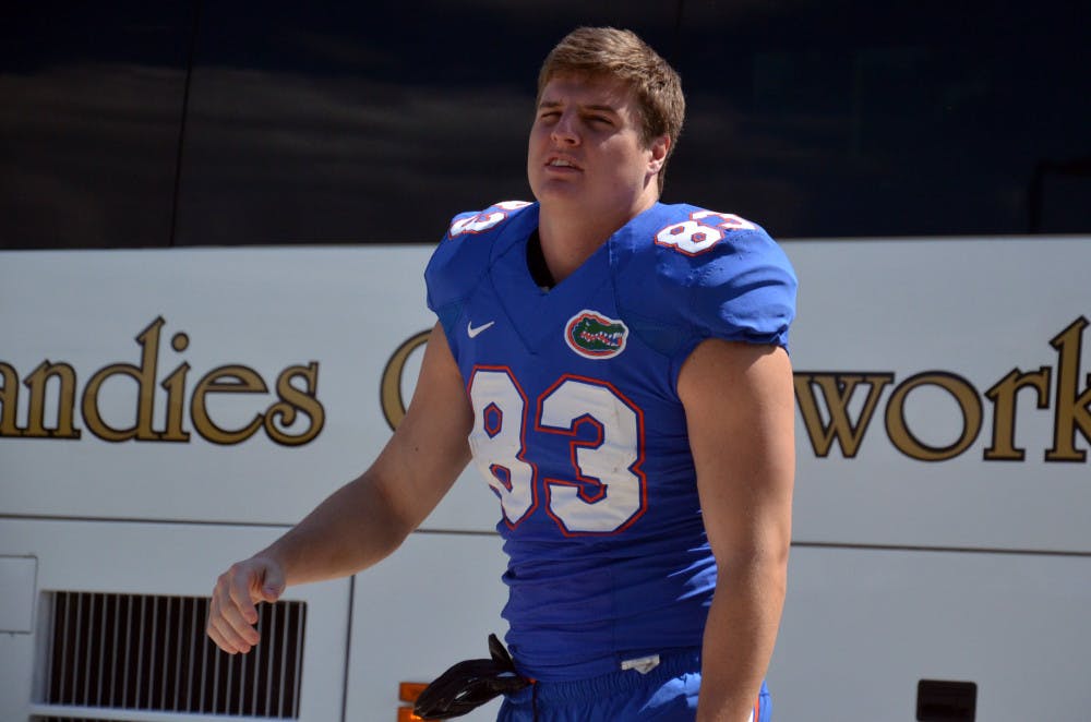 Jake McGee walks toward the practice field at Donald R. Dizney Stadium on Monday.