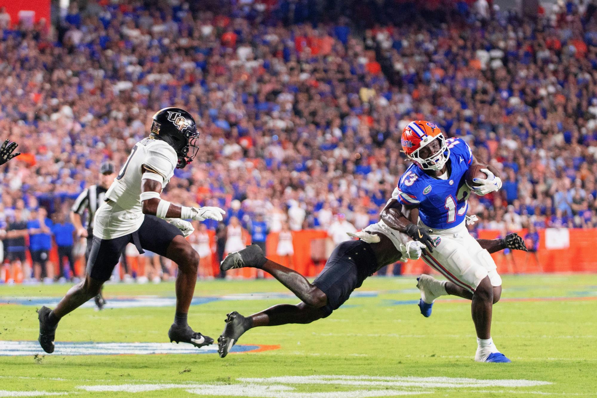 Florida Gators running back Jadan Baugh (13) runs the ball during the first half at Steve Spurrier-Florida Field at Ben Hill Griffin Stadium on Saturday, October 05, 2024.