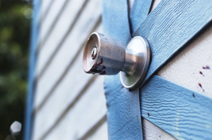 Dried blood remains on the doorknob and shed near where a southeast Gainesville man was shot Tuesday afternoon. Police are still investigating the incident.