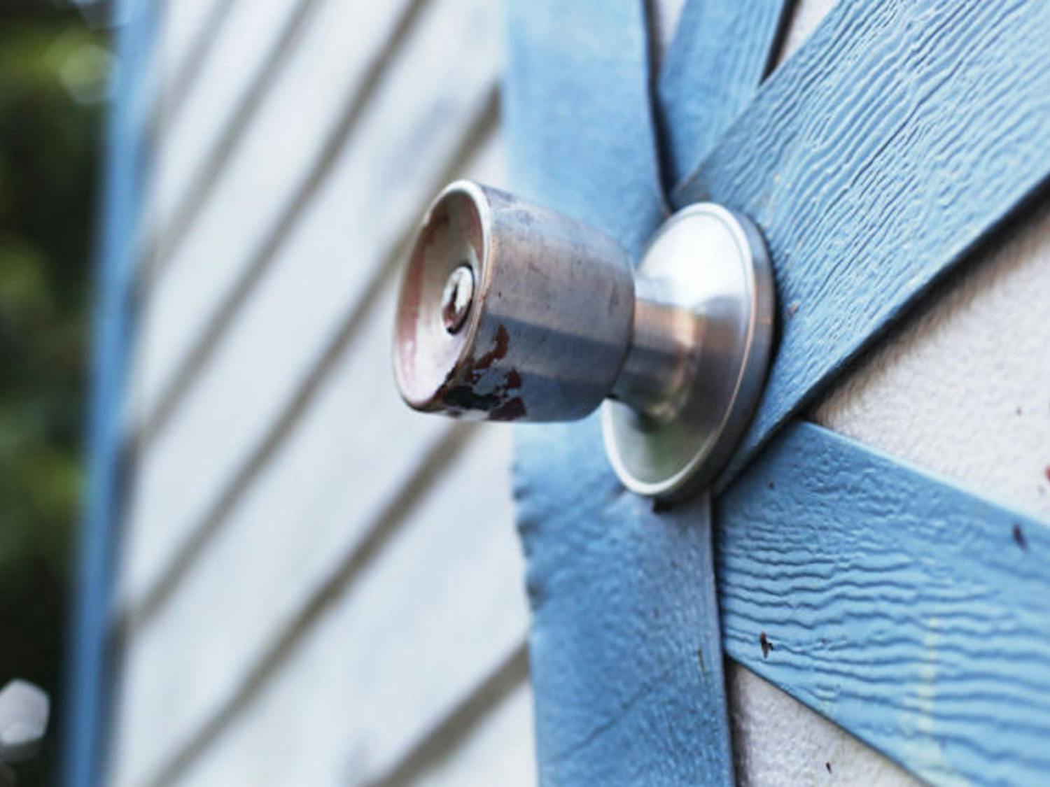 Dried blood remains on the doorknob and shed near where a southeast Gainesville man was shot Tuesday afternoon. Police are still investigating the incident.