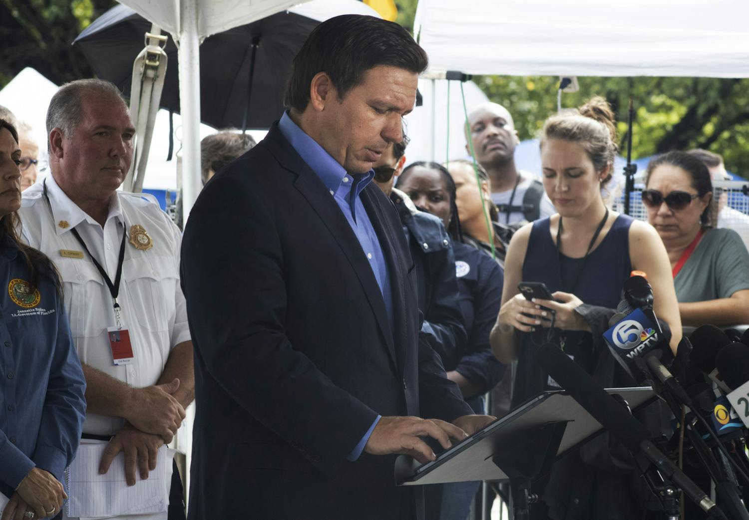 Gov. Ron DeSantis looks down at his notes as he speaks to a crowd of reporters in Surfside, Florida on Thursday, July 1, 2021. 