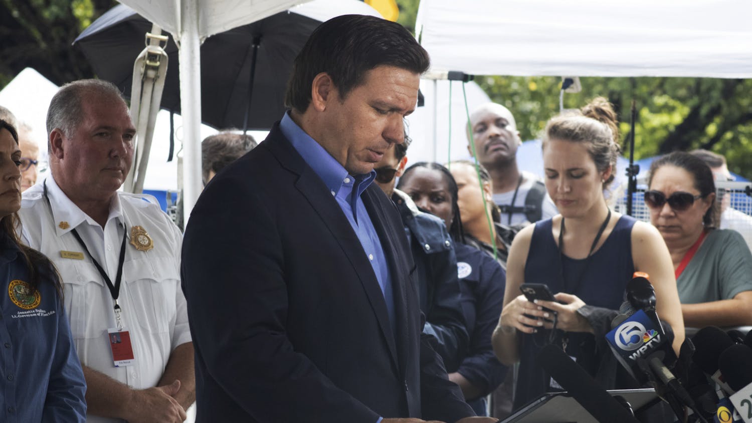 Gov. Ron DeSantis looks down at his notes as he speaks to a crowd of reporters in Surfside, Florida on Thursday, July 1, 2021. 