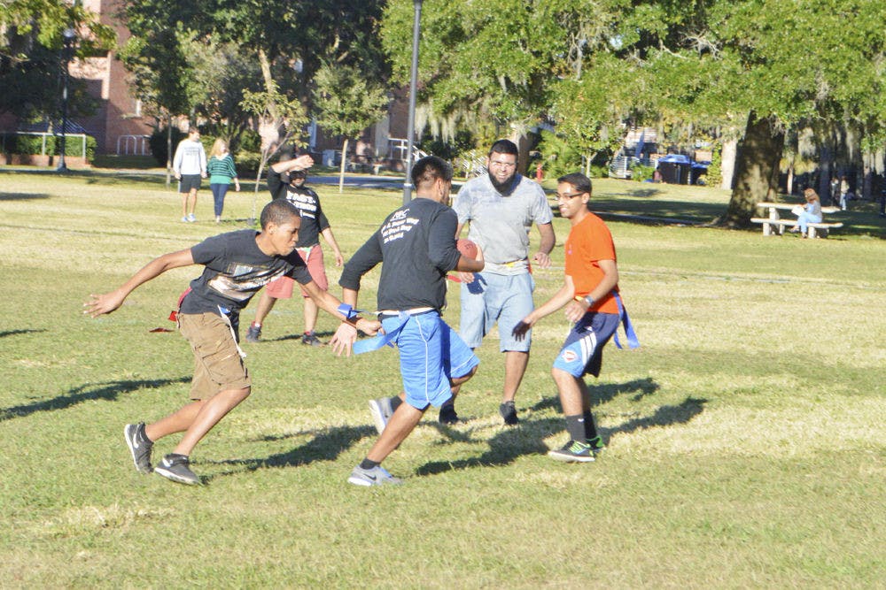 UF students spend their day off Tuesday playing flag football on the North Lawn. Veterans Day gave students the opportunity to relax in the middle of the week.