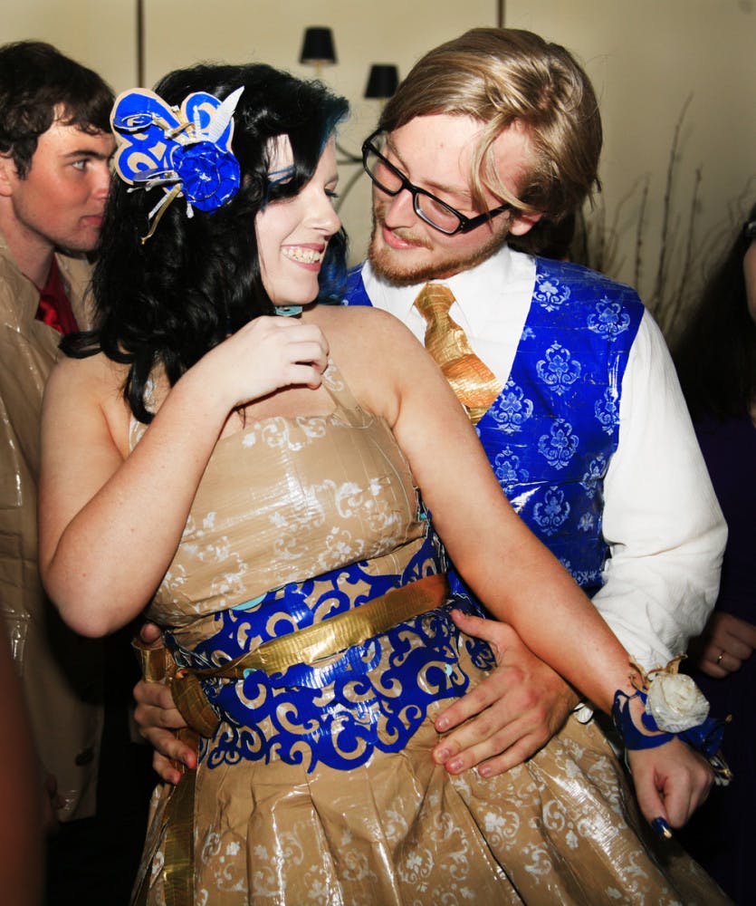 Santa Fe High School junior Coral Munkittrick, 17, and senior Connor Donlin, 18, wore outfits made of duct tape to their prom Friday. The students are participating in the Stuck at Prom Scholarship Contest.