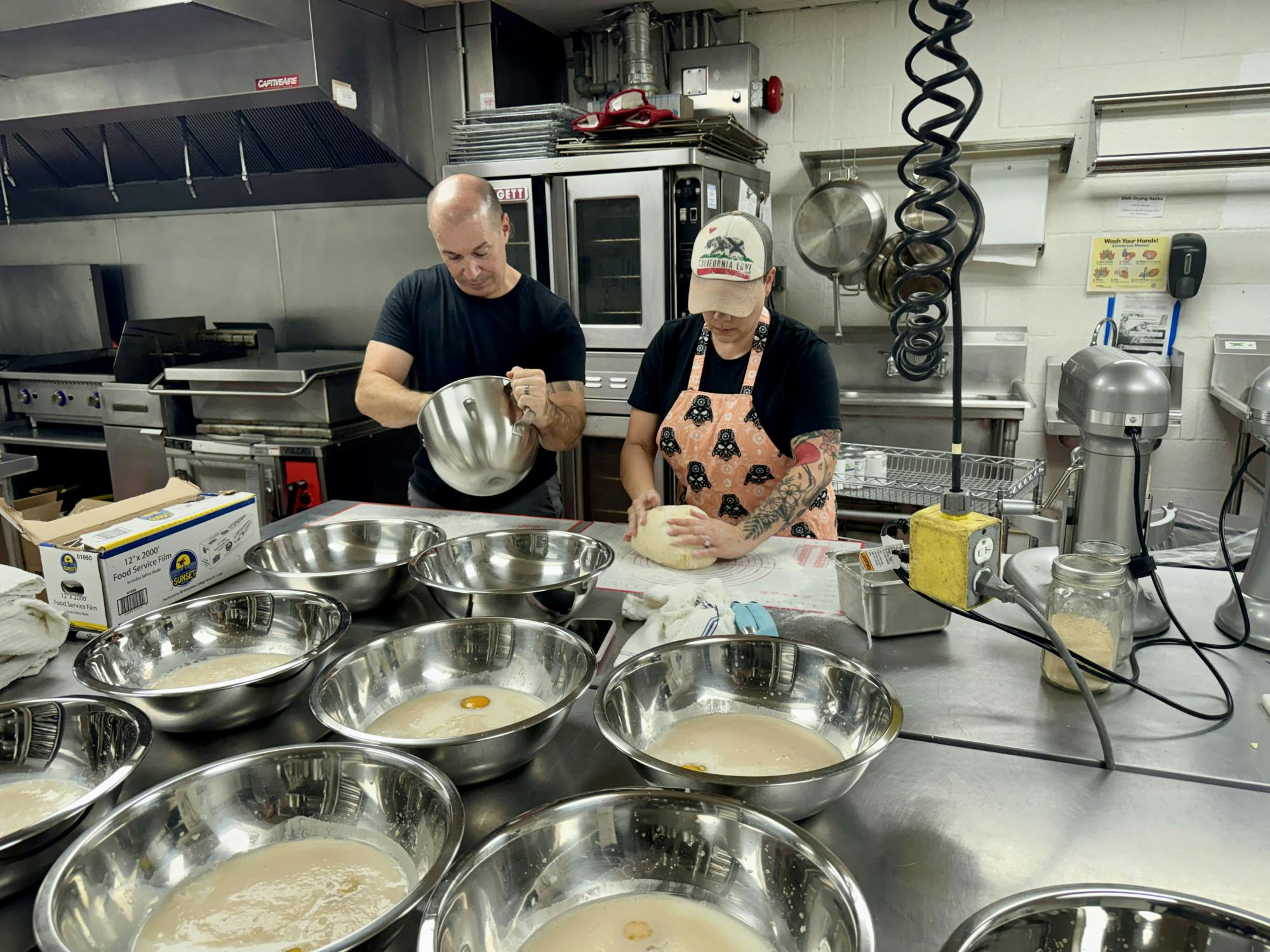 Michael and Michiyo Johnson prepare the beignet dough at Working Food on Wednesday, Feb. 26, 2025.
