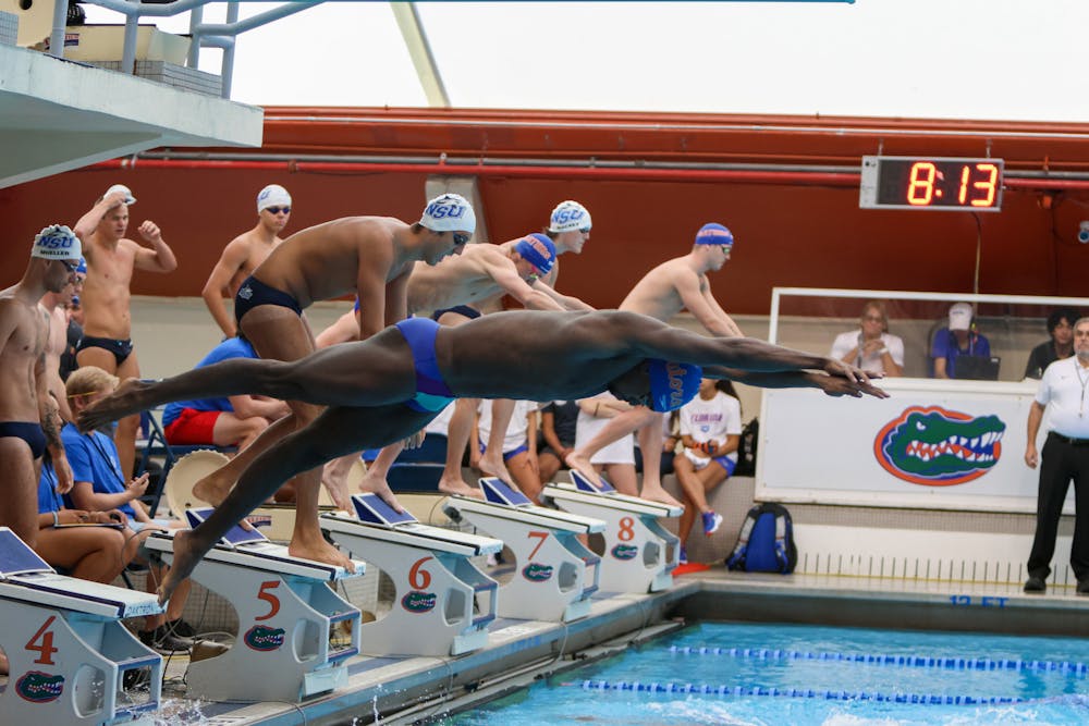 A UF swimmer dives into the pool during a meet between the Gators and Nova Southeastern Friday, Sept. 23, 2022. 