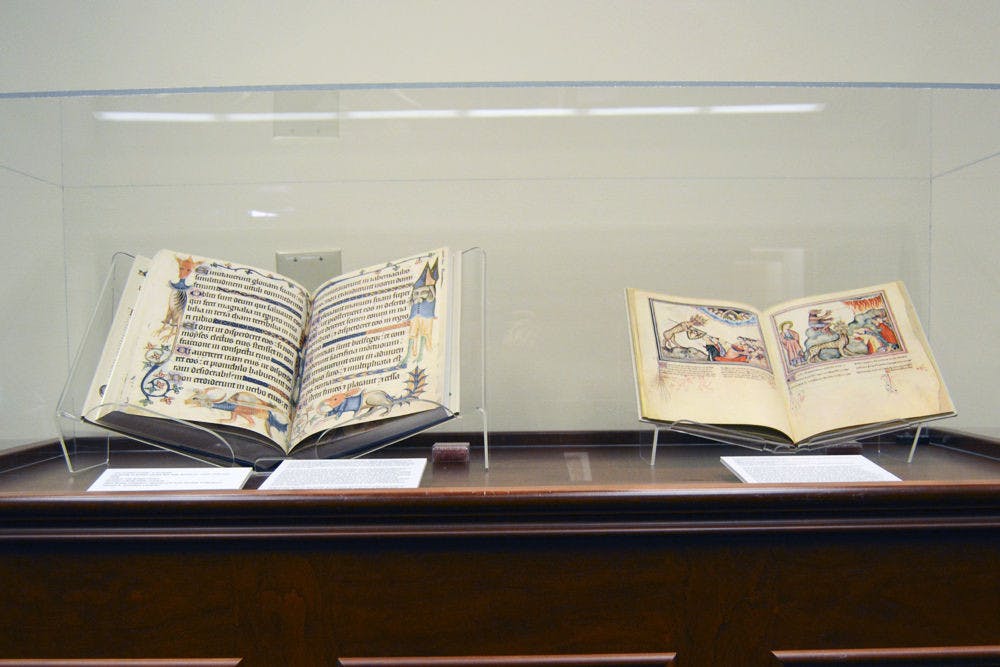 Two examples of the books on display. Left is “The Luttrell Psalter: a facsimile,” a 14th-century illuminated collection of Psalms and other devotional materials; right is “The Cloisters Apocalypse,” an illustrated 14th-century version of the Revelation of St. John.