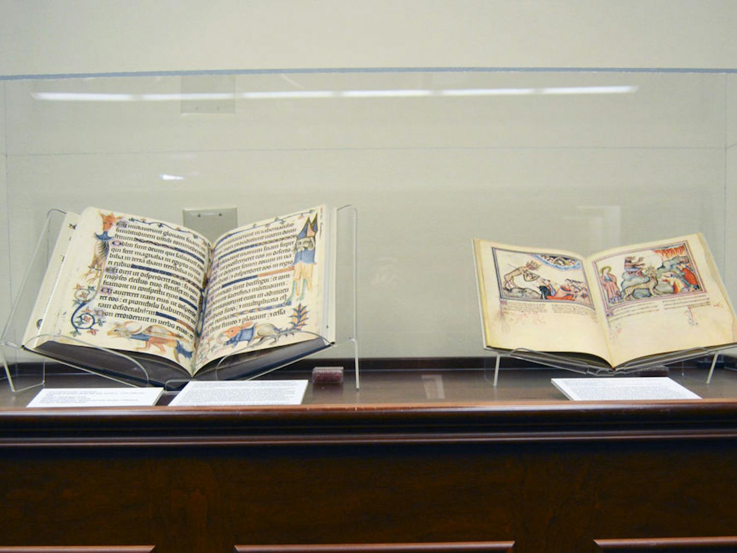 Two examples of the books on display. Left is “The Luttrell Psalter: a facsimile,” a 14th-century illuminated collection of Psalms and other devotional materials; right is “The Cloisters Apocalypse,” an illustrated 14th-century version of the Revelation of St. John.