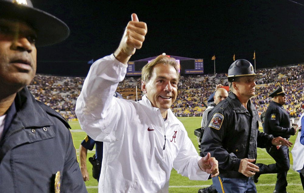 <p>Alabama coach Nick Saban acknowledges fans as he runs off the field after Alabama's 20-13 overtime win over LSU in Baton Rouge, Louisiana on Nov. 9.</p>