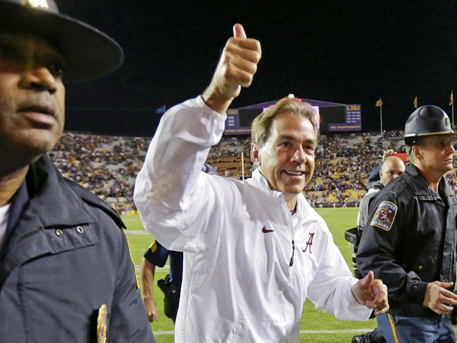 Alabama coach Nick Saban acknowledges fans as he runs off the field after Alabama's 20-13 overtime win over LSU in Baton Rouge, Louisiana on Nov. 9.