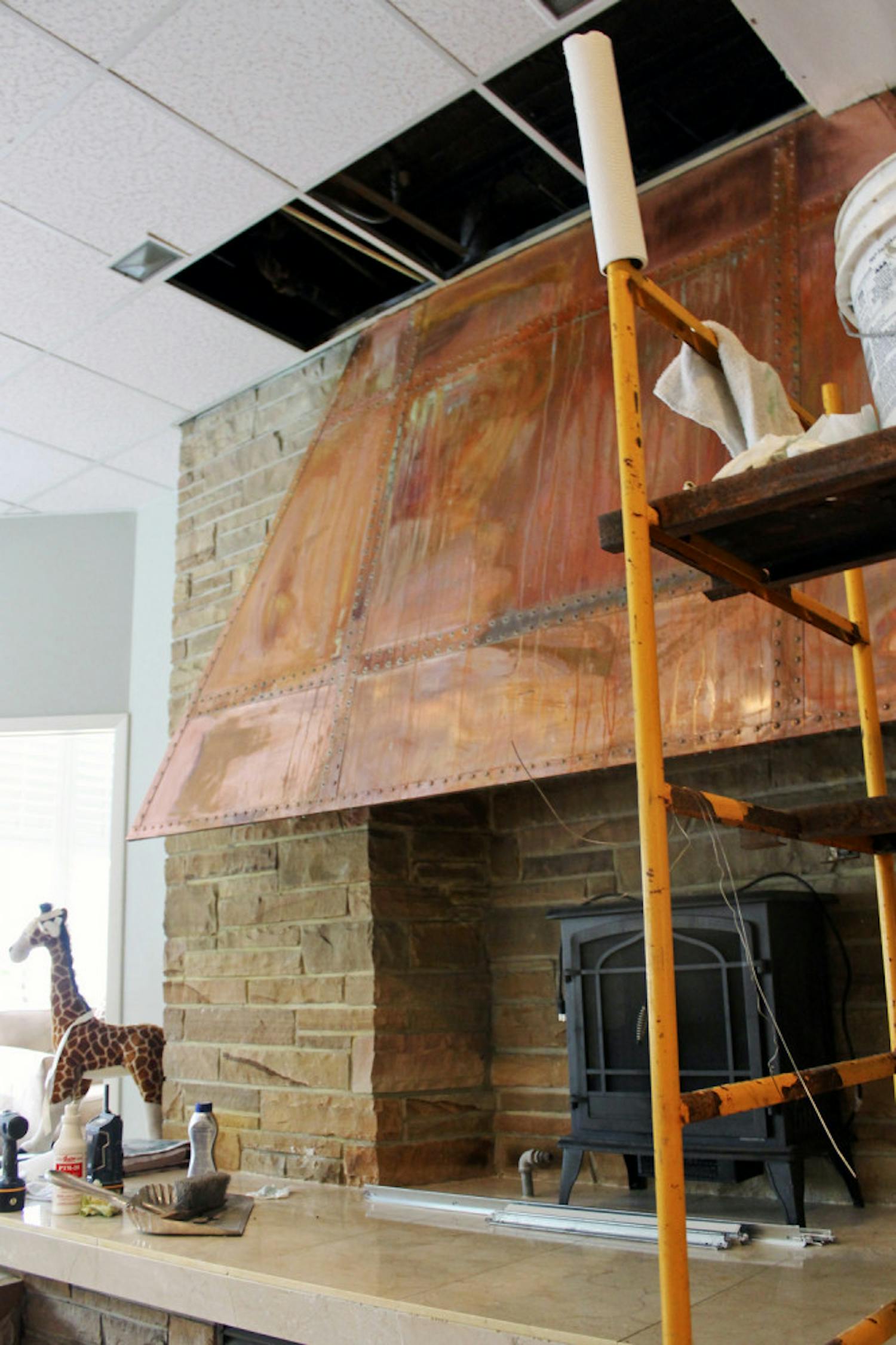 Water streaks run down the rusted hood of a fireplace in the Alpha Epsilon Phi sorority house on West Panhellenic Drive.
