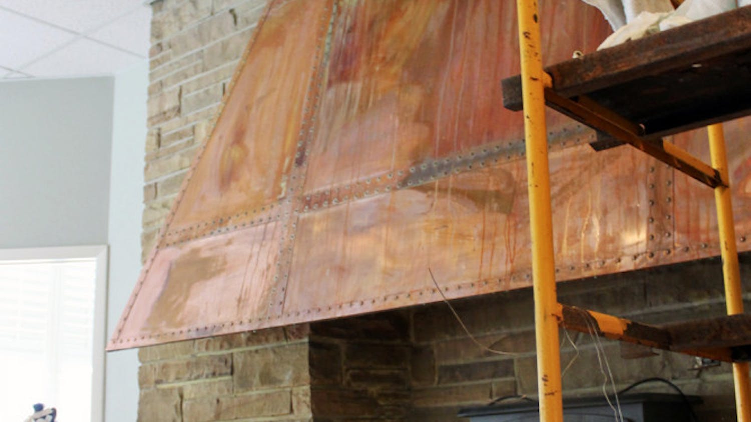 Water streaks run down the rusted hood of a fireplace in the Alpha Epsilon Phi sorority house on West Panhellenic Drive.