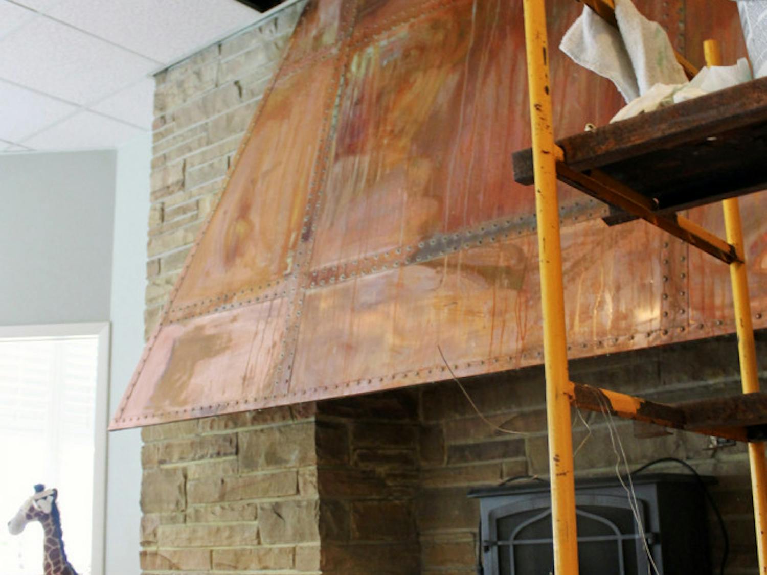 Water streaks run down the rusted hood of a fireplace in the Alpha Epsilon Phi sorority house on West Panhellenic Drive.
