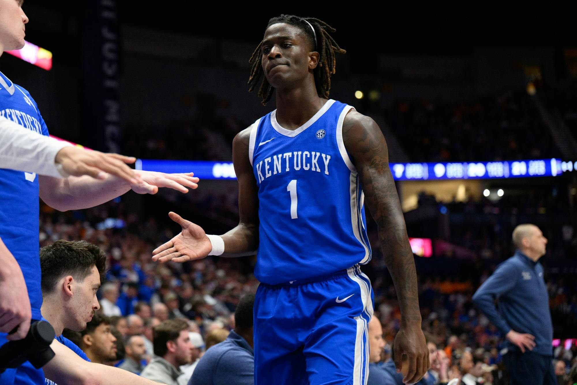 Kentucky guard Denzel Aberdeen (1) high fives his bench after being subbed out during the first half of an SEC Men's Basketball Tournament quarterfinal game against Florida, Friday, March 13, 2026, in Nashville, Tenn.